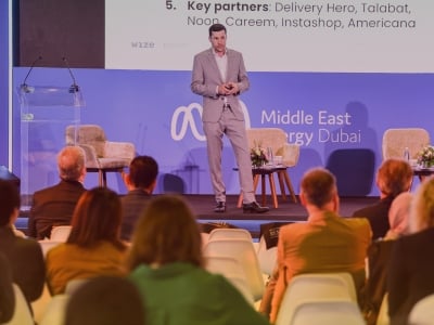 Speaker on stage addressing the audience