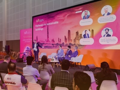 Moderator introducing guest speakers on stage